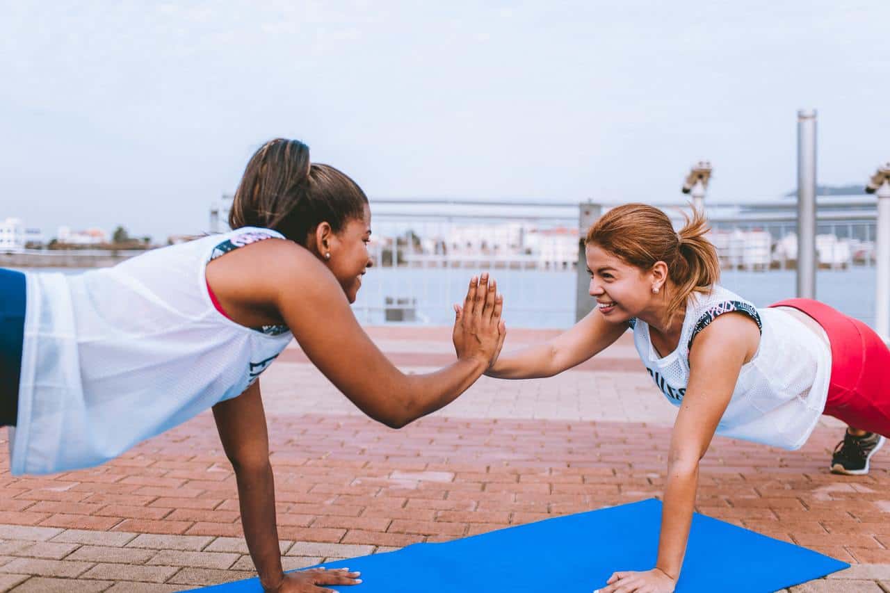 Two Woman Doing Exercise from the post How To Wake Up Early In The Morning Without Feeling Tired